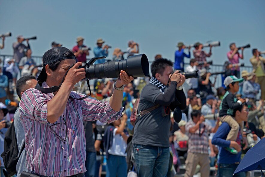 Spectators take pictures as an F-16 Fighting Falcon performs an aerial demonstration during the 2016 Friendship Day at Marine Corps Air Station Iwakuni, Japan, May 5, 2016. This year was the 40th annual Friendship Day, offering a culturally enriching experience that displays the mutual support shared between the U.S. and Japan. (U.S. Air Force photo by Senior Airman David Owsianka/Released)