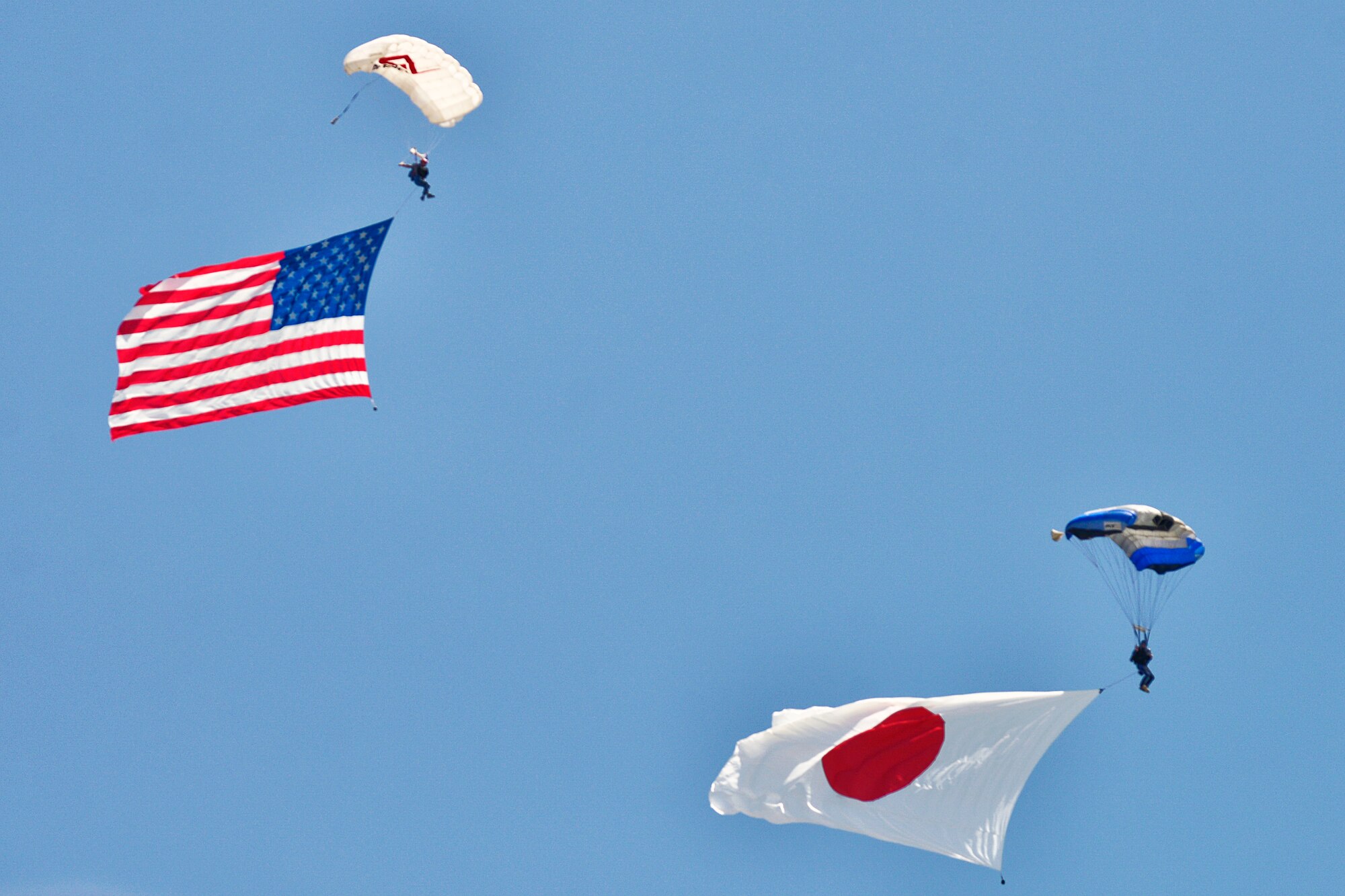 Jumpers glide to the ground with U.S. and Japan flags during the 2016 Friendship Day at Marine Corps Air Station Iwakuni, Japan, May 5, 2016. The event showcased a variety of static displays, aviation performances and demonstrations, and provided food and entertainment for guests of the largest single-day event at Iwakuni each year. (U.S. Air Force photo by Senior Airman David Owsianka/Released)