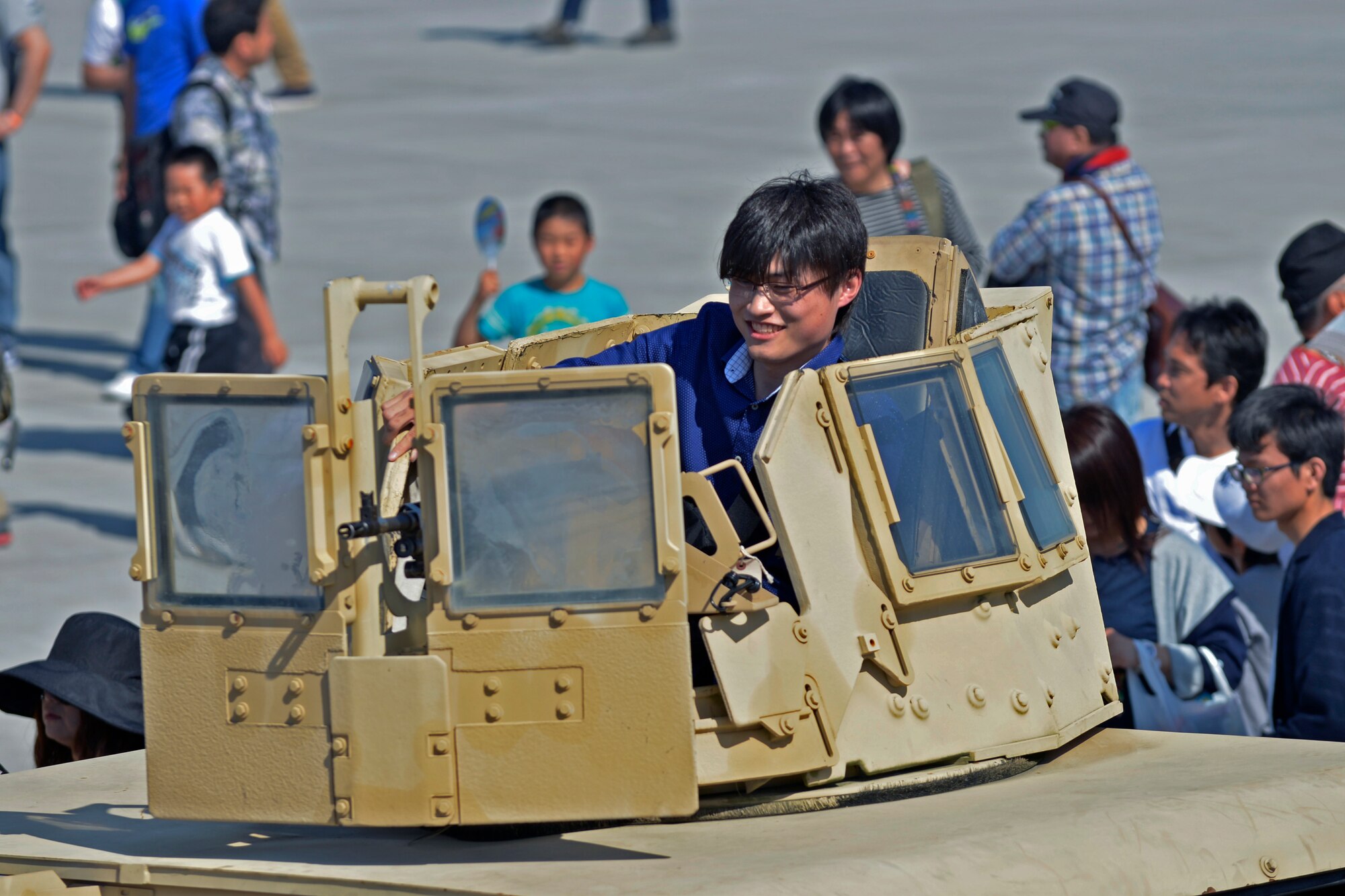 A spectator at the 2016 Friendship Day looks at a machine gun on top of a Humvee at Marine Corps Air Station Iwakuni, Japan, May 5, 2016. Approximately 175,000 guests attended the event. This year was the 40th annual Friendship Day, offering a culturally enriching experience that displays the mutual support shared between the U.S. and Japan. (U.S. Air Force photo by Senior Airman David Owsianka/Released)
