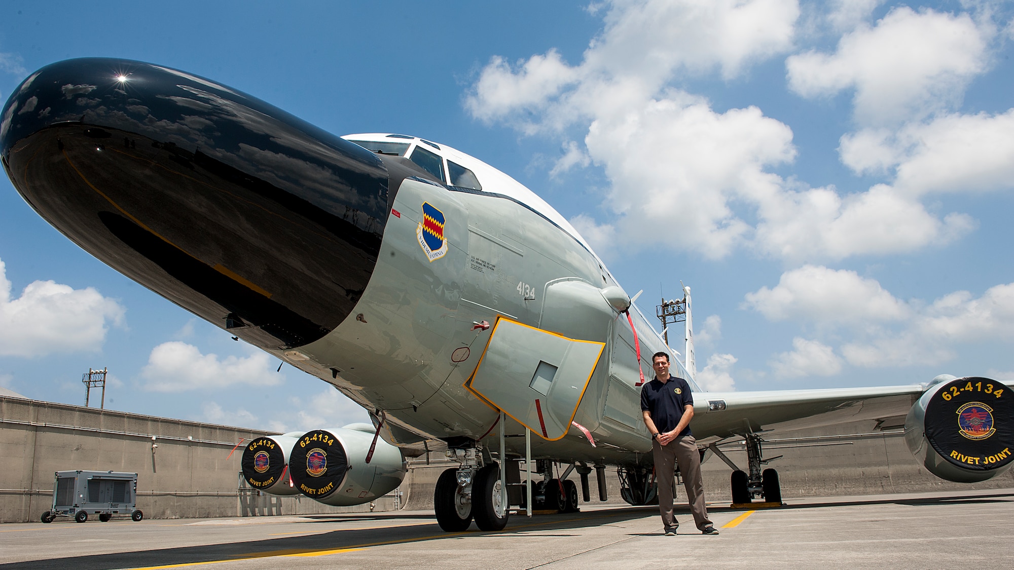 Curtis Towne, Department of Defense civilian employee, stands next to an RC-135W Rivet Joint April 29, 2016, at Kadena Air Base, Japan. The RC-135W is assigned to the 82nd Reconnaissance Squadron, but is used for missions with the 390th Intelligence Squadron. Towne was assigned to the 390th Intelligence Squadron in 2001 when he was detained for 12 days by the People’s Republic of China following a mid-air collision with a Chinese jet. (U.S. Air Force photo by Airman 1st Class Lynette M. Rolen)