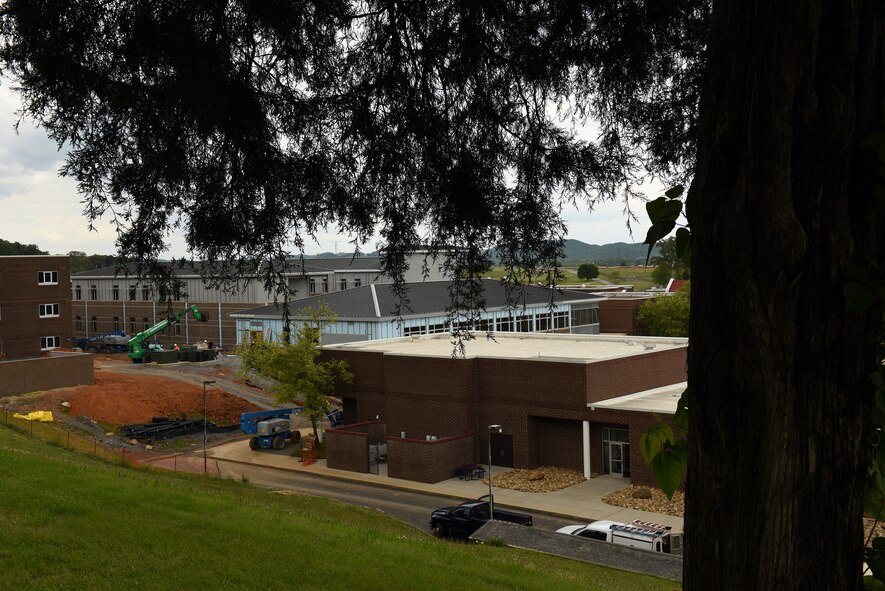 MCGHEE TYSON AIR NATIONAL GUARD BASE, Tenn. - As seen through a conifir branch from the northwest hill, the new facility construction is nestled between Spruance Hall, right, Moon Hall, far left, and the Smoky Mountains, far background, May 6, 2016, at the I.G. Brown Training and Education Center. (U.S. Air National Guard photo by Master Sgt. Mike R. Smith/Released)