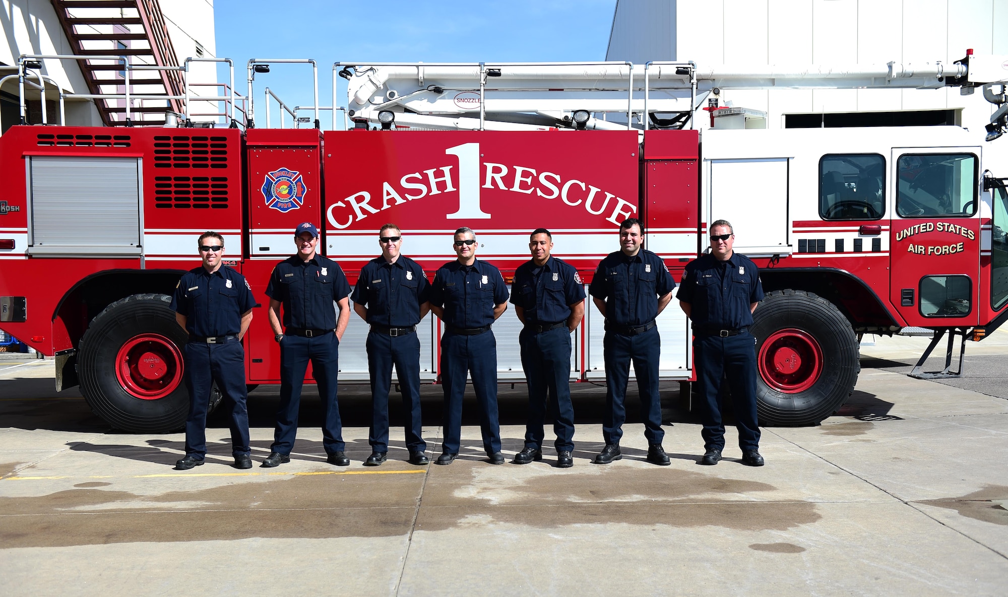 Members of the Buckley Fire Department stand with a fire truck May 5, 2016, on Buckley Air Force Base, Colo. The goal of Public Service Recognition Week is to foster esprit de corps and recognize all of the contributions and knowledge that civilian government employees bring to our nation’s defense and their local communities. (U.S. Air Force photo by Airman 1st Class Gabrielle Spradling/Released)