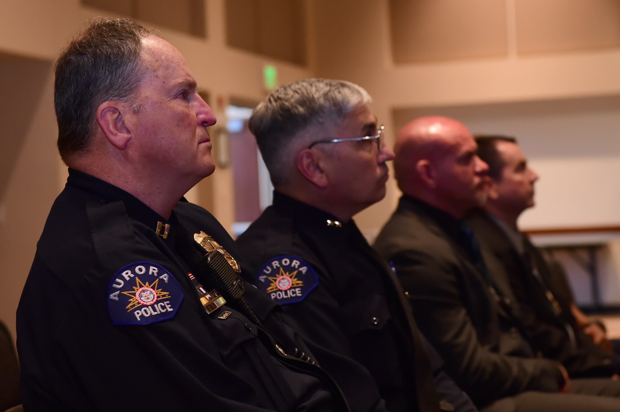Law enforcement officers from the Aurora Police Department look on during a ceremony commemorating the beginning of National Police Week May 9, 2016, at the Leadership Development Center on Buckley Air Force Base, Colo. National Police Week was first established by Congress in 1962 and honors those who have lost their lives in the line of duty. (U.S. Air Force photo by Airman 1st Class Luke W. Nowakowski/Released)