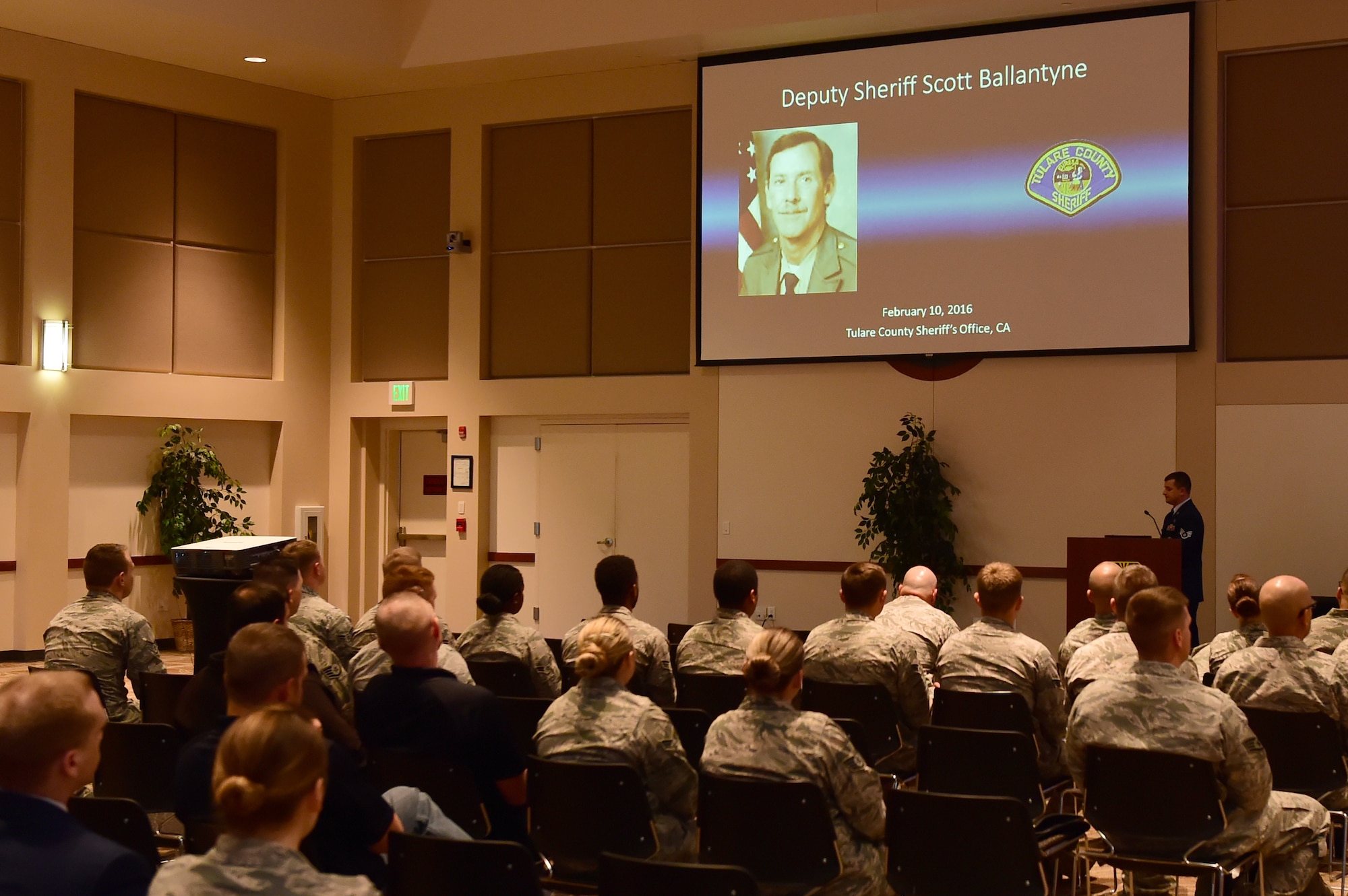 Audience members watch a presentation highlighting fallen law enforcement officers May 9, 2016, at the Leadership Development Center on Buckley Air Force Base, Colo. Team Buckley salutes the men and women who put their lives on the line by hosting National Police Week annually. (U.S. Air Force photo by Airman 1st Class Luke W. Nowakowski/Released)