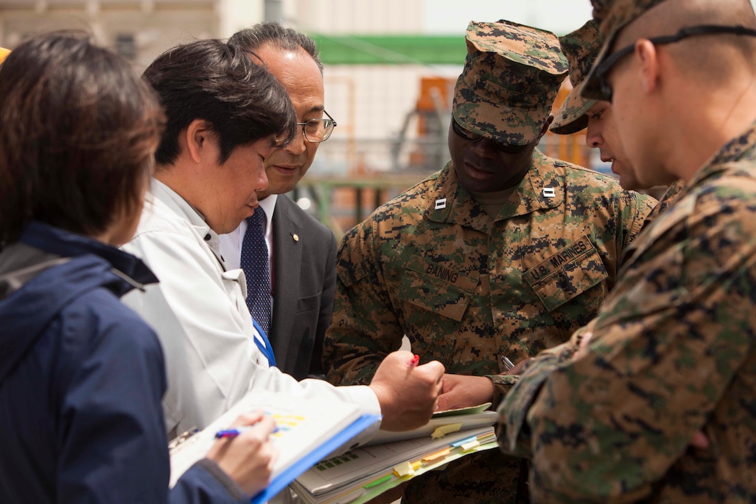 SENDAI, Japan – Capt. Emmanuel Baning, the Officer Conducting Exercise for Artillery Relocation Training Program 16-1, works with Japanese embarkation contractors overseeing the unloading of artillery at Sendai Port on May 9, 2016. Baning is with 3rd Battalion, 12th Marine Regiment, 3rd Marine Division, III Marine Expeditionary Force, based out of Camp Hansen, Okinawa, Japan and is from Washington, D.C.