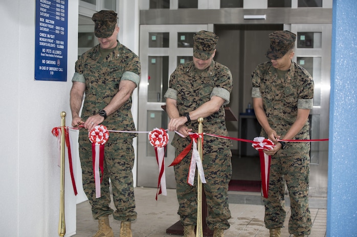 From left to right, Col. Daniel Shipley, commanding officer of Marine Aircraft Group 12, Col. Robert V. Boucher, commanding officer of Marine Corps Air Station Iwakuni, and Chief Warrant Officer Jonathan Solla, postal officer with Headquarters and Headquarters Squadron, conduct the grand opening ceremony for the new south side post office on MCAS Iwakuni, Japan, May 9, 2016. The new post office will start delivering and sending mail on opening day. (U.S. Marine Corps photo by Cpl. Nathan Wicks/Released) 