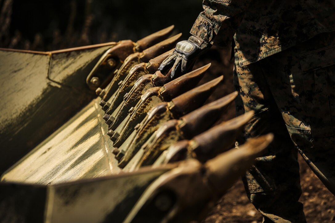 CAMP RODRIGUEZ LIVE FIRE COMPLEX, South Korea — A Marine slowly ground guides a 130G Road Grader during Korea Explosive Ordnance Disposal Exercise May 8, 2016 at Camp Rodriguez Live Fire Complex, South Korea. The Marines used three different vehicles to create pathways and flatten an area for an ammunition supply point. Marines are with Support Company, 9th Engineer Support Battalion, III Marine Expeditionary Force. (U.S. Marine Corps photo by Cpl. Isaac Ibarra/Released)