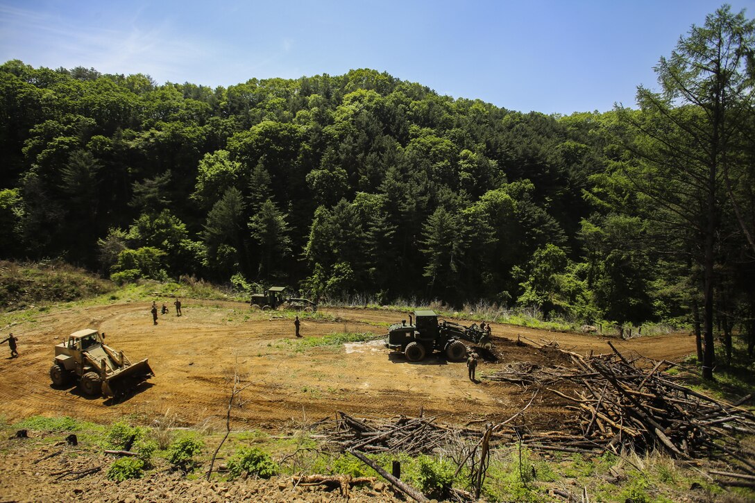 CAMP RODRIGUEZ LIVE FIRE COMPLEX, South Korea — Marines clear an area for an ammunition supply point May 8, 2016 during Korea Explosive Ordnance Disposal Exercise at Camp Rodriguez Live Fire Complex, South Korea. The ranges are currently being prepared for EOD live fire training scheduled for the next couple of weeks. Marines are with Support Company, 9th Engineer Support Battalion, III Marine Expeditionary Force. (U.S. Marine Corps photo by Cpl. Isaac Ibarra/Released)