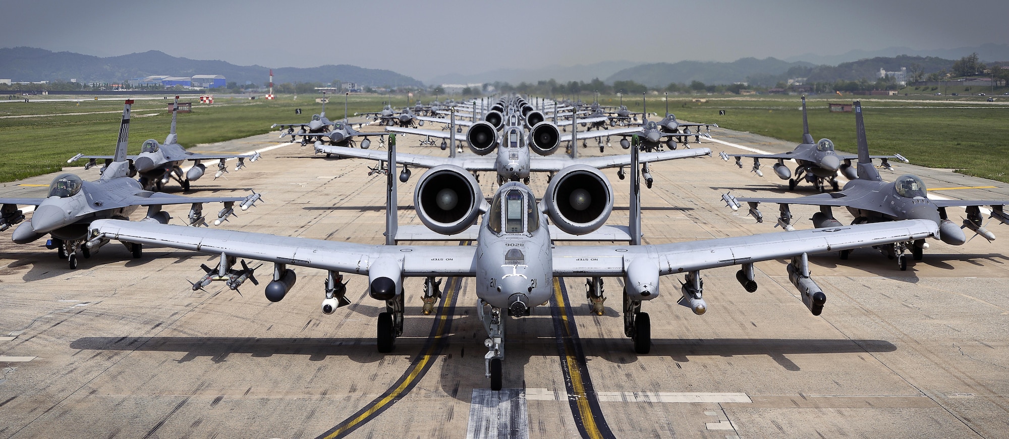 A-10 Thunderbolt II and F-16 Fighting Falcon fighter aircraft perform an 'Elephant Walk' on the runway this week during Exercise Beverly Herd 16-01 at Osan Air Base, Republic of Korea.  The Elephant Walk was a demonstration of U.S. Air Force capabilities and strength and showcases the wing's ability to generate combat airpower in an expedient manner in order to respond to simulated contingency operations. The A-10 Thunderbolt II aircraft are from the 25th Fighter Squadron "Draggins" and the F-16 Fighting Falcon aircraft are from the 36th Fighter Squadron "Fiends" of the 51st Fighter Wing, Osan AB, ROK; the additional F-16 aircraft are from the 179th Fighter Squadron "Bulldogs" of the 148th Fighter Wing out of Duluth Air National Guard Base, Minnesota. (U.S. Air Force photo by Tech. Sgt. Travis Edwards/Released)