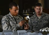 Senior Airman Briant Rogers, 51st Munitions Squadron crew member, prepares to connect a Joint Direct Attack Munition to a firmware update under the supervision of Staff Sgt. Jeffrey Snuffin, 51st MUNS conventional maintenance crew chief, May 9, 2016, at Osan Air Base, Republic of Korea. The 51st MUNS crew were installing an update on the munition’s guidance firmware during Exercise Beverly Herd 16-01. (U.S. Air Force photo by Senior Airman Victor J. Caputo/Released)