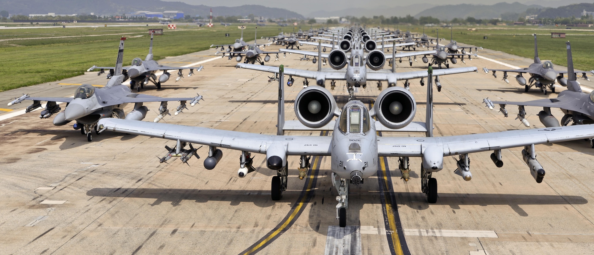 A-10 Thunderbolt II and F-16 Fighting Falcon fighter aircraft perform an 'Elephant Walk' on the runway this week during Exercise Beverly Herd 16-01 at Osan Air Base, Republic of Korea.  The Elephant Walk was a demonstration of U.S. Air Force capabilities and strength and showcases the wing's ability to generate combat airpower in an expedient manner in order to respond to simulated contingency operations. The A-10 Thunderbolt II aircraft are the 25th Fighter Squadron "Draggins" and the F-16 Fighting Falcon aircraft are the 36th Fighter Squadron "Friends" from the 51st Fighter Wing, Osan AB, ROK; the additional F-16 aircraft are the 179th Fighter Squadron "Bulldogs" from the 148th Fighter Wing out of Duluth Air National Guard Base, Minnesota. (U.S. Air Force photo by Tech. Sgt. Travis Edwards/Released) 