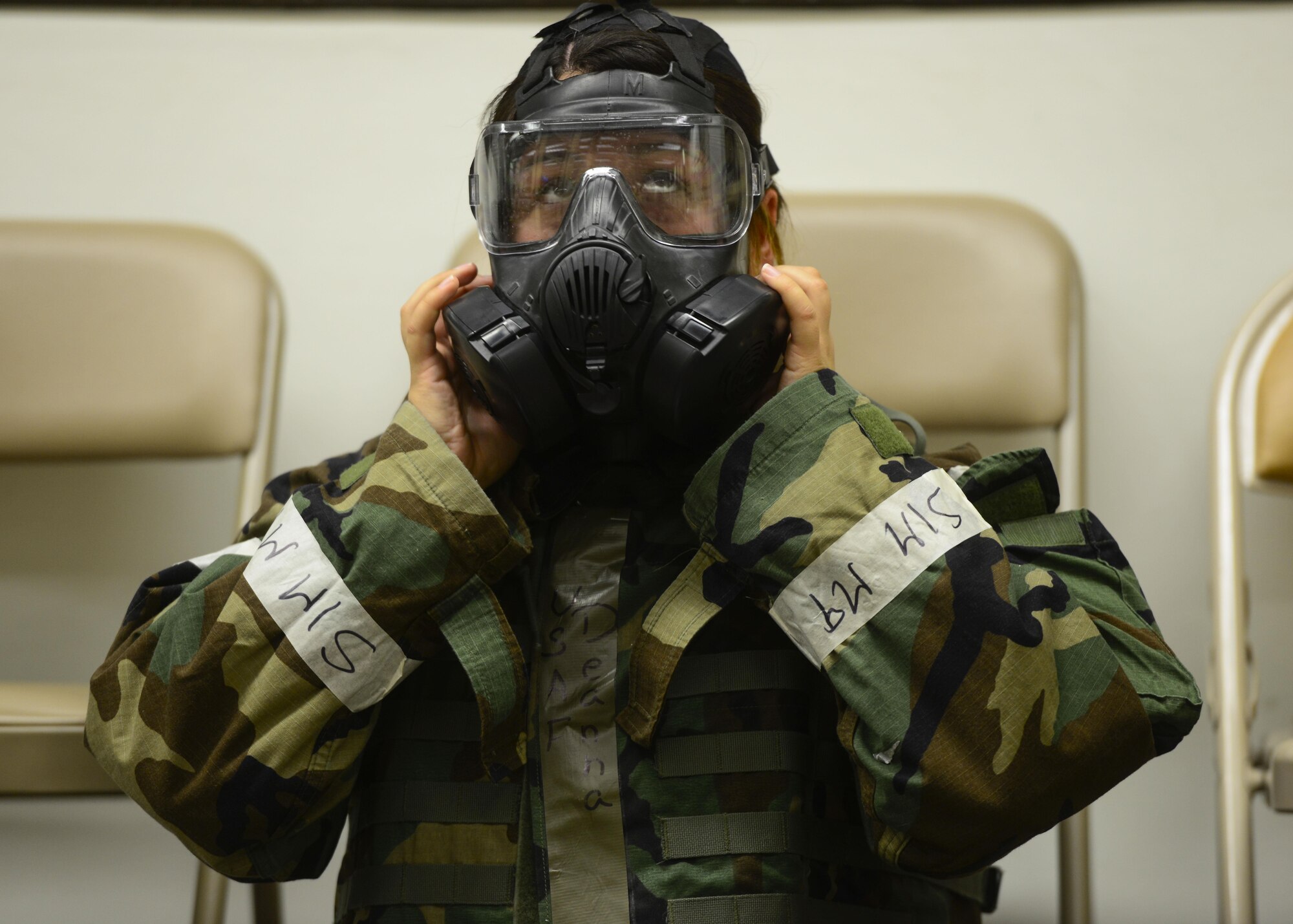 Senior Airman Deanna Sena, 51st Medical Operations Squadron immunizations technician, removes her M-50 gas mask during readiness exercise Beverly Herd 16-01, May 9, 2016, at Osan Air Base, Republic of Korea. Medical personal treated patients with simulated injuries during the exercise while simultaneously ensuring they utilized the proper Mission Oriented Protective Posture gear. (U.S. Air Force photo by Senior Airman Victor J. Caputo/Released)