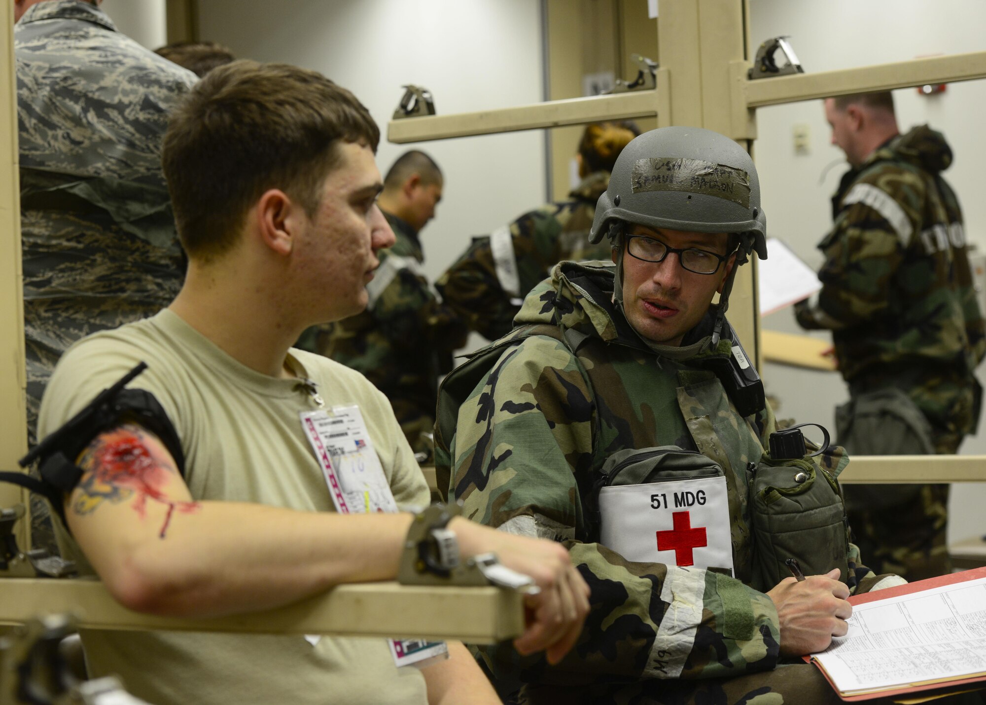 Capt. Samuel Madson, right, 51st Medical Group Delayed Team chief, diagnoses a patient during readiness exercise Beverly Herd 16-01, May 9, 2016, at Osan Air Base, Republic of Korea. Madson was in charge of the Delayed Team, which treated patients with simulated injuries ranging from head trauma to gunshot wounds. (U.S. Air Force photo by Senior Airman Victor J. Caputo/Released)