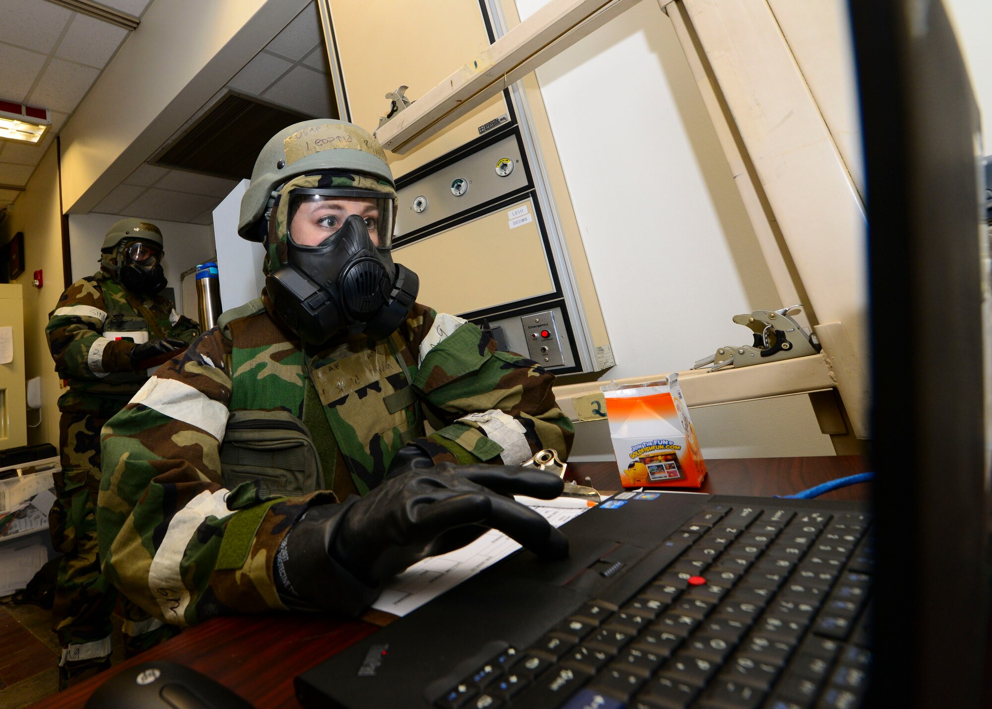 Airman 1st Class Olivia Leopold, 51st Medical Operations Squadron outpatient records technician, reads over a patient’s digital record during readiness exercise Beverly Herd 16-01, May 9, 2016, at Osan Air Base, Republic of Korea. Members of Team Osan had to don the proper Mission Oriented Protective Posture gear depending on the alert level while still maintaining the ability to accomplish their task at hand. (U.S. Air Force photo by Senior Airman Victor J. Caputo/Released)