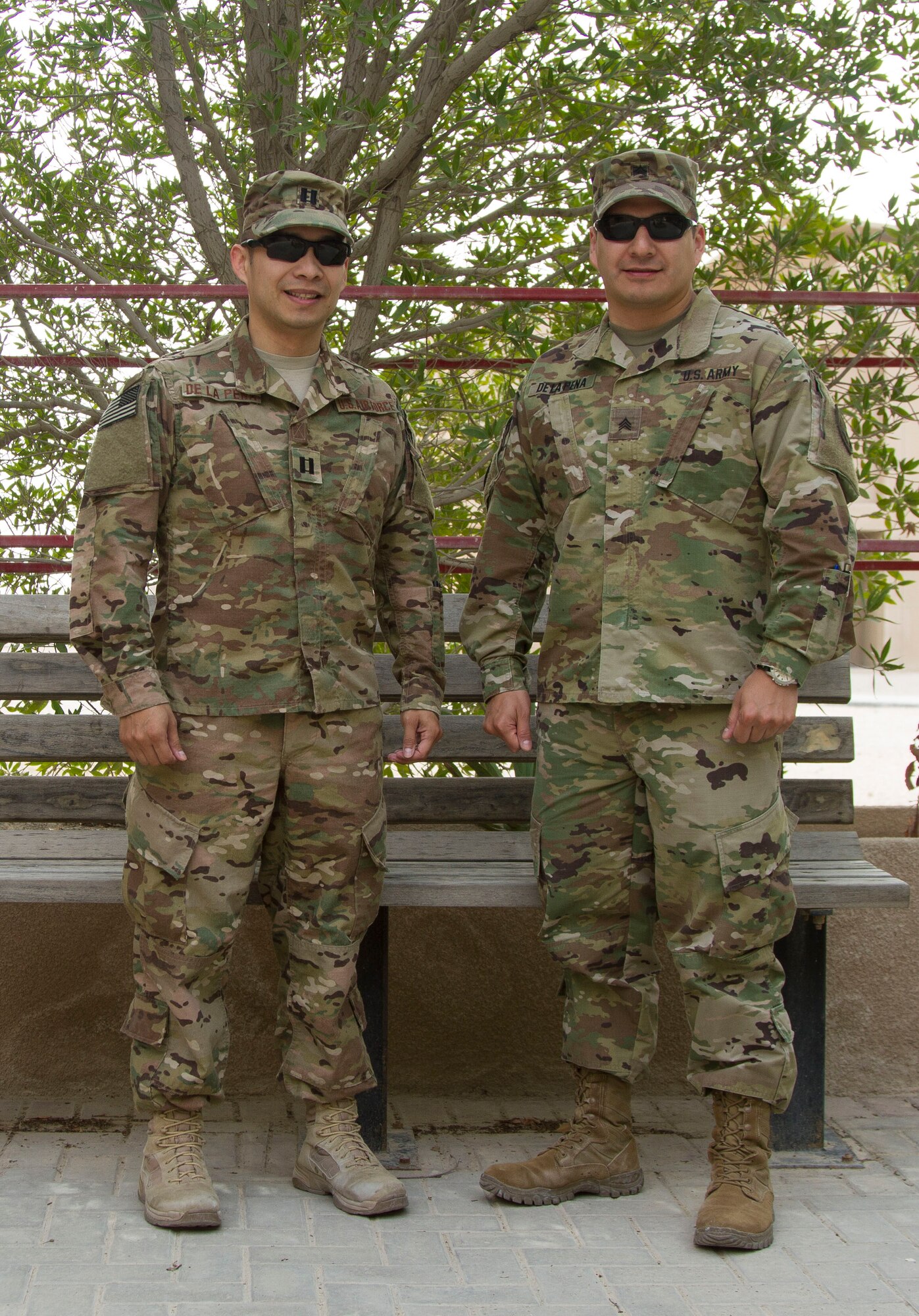 Cpt. Christopher De La Pena, Deputy Director AFCENT Lessons Learned Directorate, and Sgt. Nicholas De La Pena, Broadcast NCO AFCENT Public Affairs, pose together at Al Udeid Air Base, Qatar March 18. The brothers deployed together for the second time in 2016. (U.S. Army photo by Spc. Travis Terreo)