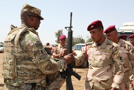 U.S. Army 1st Sgt. Gabriel Montgomery with the 524th Combat Sustainment Support Battalion, 17th Sustainment Brigade, Task Force Battle Born, issues an M16 rifle to an Iraqi soldier assigned to Iraq’s 4th Battalion, 23rd Brigade, during an Iraqi Train and Equip Fund issuing point at Camp Taji, Iraq, April 16, 2016. At events like these Coalition partners provide weapons and other equipment to the Iraqi soldiers to assist them in defeating Daesh. ITEF, facilitated by Combined Joint Task Force – Operation Inherent Resolve, provides essential weapons and equipment to Iraqi Security Forces as part of the building partner capacity mission.  