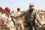 U.S. Army First Sgt. Gabriel Montgomery with 524th Combat Sustainment Support Battalion, 17th Sustainment Brigade, Task Force Battle Born, issues an M16 rifle to an Iraqi soldier assigned to Iraq’s 4th Battalion, 23rd Brigade, during an Iraqi Train and Equip Fund issuing point at Camp Taji, Iraq, April 16, 2016. This event is one of several where the United States provides weapons and other equipment to the Iraqi soldiers to assist them in defeating Daesh. 