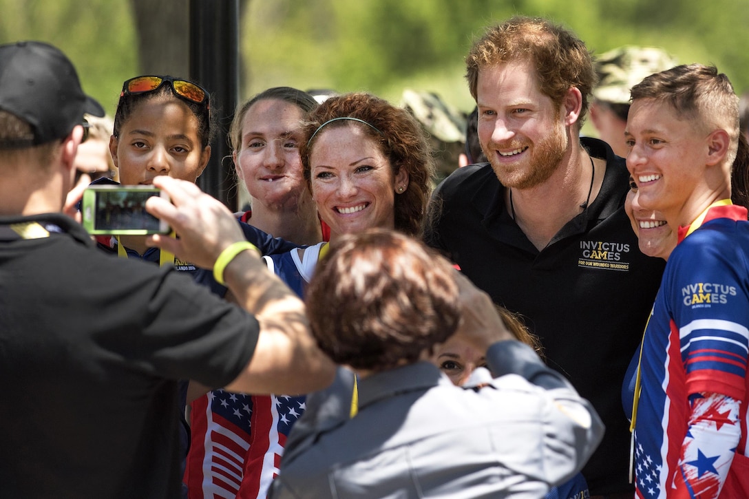 Prince Harry, second from right, and, left to right, Marine Corps Sgt. Gabby Graves-Wake, Army Sgt. 1st Class Katie Kuiper, Marine Corps veteran Jenae Piper, Air Force Staff Sgt. Sebastiana Lopez-Arellano and Army veteran Aaron Stewart pose for a photo after competing in cycling events during the 2016 Invictus Games in Orlando, Fla., May 9, 2016. DoD photo by Roger Wollenberg