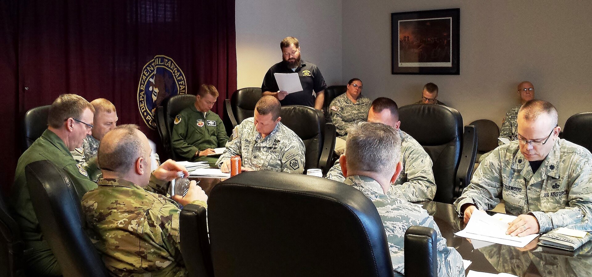 Senior staff members of the Pennsylvania Army and Air National Guard listen to an operational brief by Shane Woodmancy, an emergency management specialist with Pennsylvania Emergency Management Agency during Vibrant Response 2016. The Pennsylvania National Guard is the agency’s partner and works under its direction during state activations. 