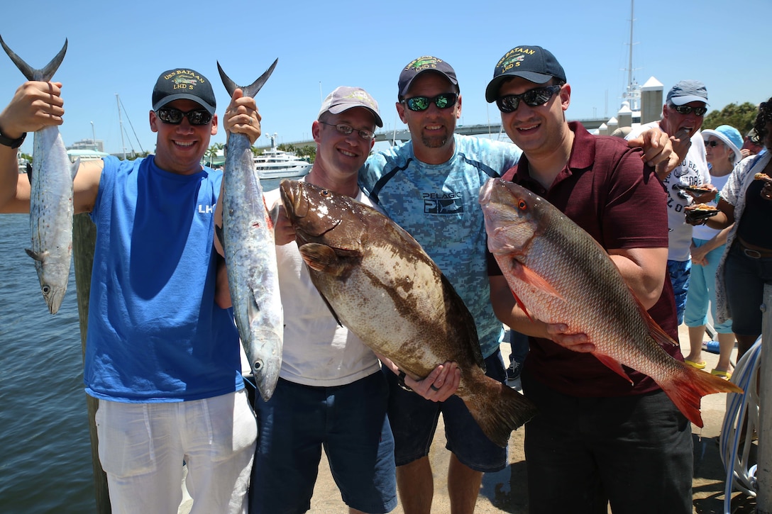 Sailors from the USS Bataan pose for a photo to show off their catches during the Take a Hero Fishing event as part of Fleet Week Port Everglades, Fort Lauderdale, Fla., May 5, 2016. The Take a Hero Fishing event gave Marines and Sailors the opportunity to spend the day off the Florida coast with local sport fisherman and boat owners while engaging in some friendly competition to see who can catch the biggest fish. (U.S. Marine Corps photo by Lance Cpl. Brianna Gaudi/Released.)