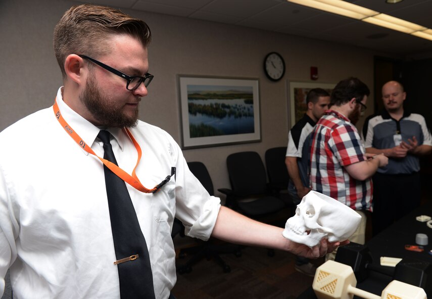 Stephen Fields, Network Operations Division, examines a 3-D printed skull during an Innovation Day presentation at the National Air and Space Intelligence Center at Wright-Patterson Air Force Base, Ohio, May 6, 2016. Airmen from across NASIC spent the day considering ways to improve the organization and enhance the mission. (U.S. Air Force photo/Senior Airman Samuel Earick)
