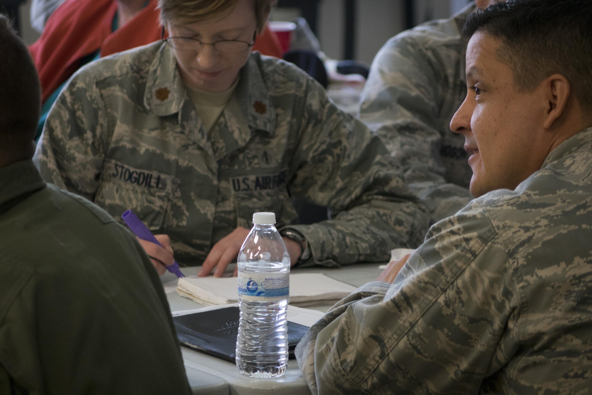 Students attending Green Dot leadership training write down personal barriers they might have towards intervening in a given scenario April 19, 2016, at Mountain Home Air Force Base, Idaho. Bystander intervention is a key concept of Green Dot. (U.S. Air Force photo by Tech. Sgt. Samuel Morse/Released)