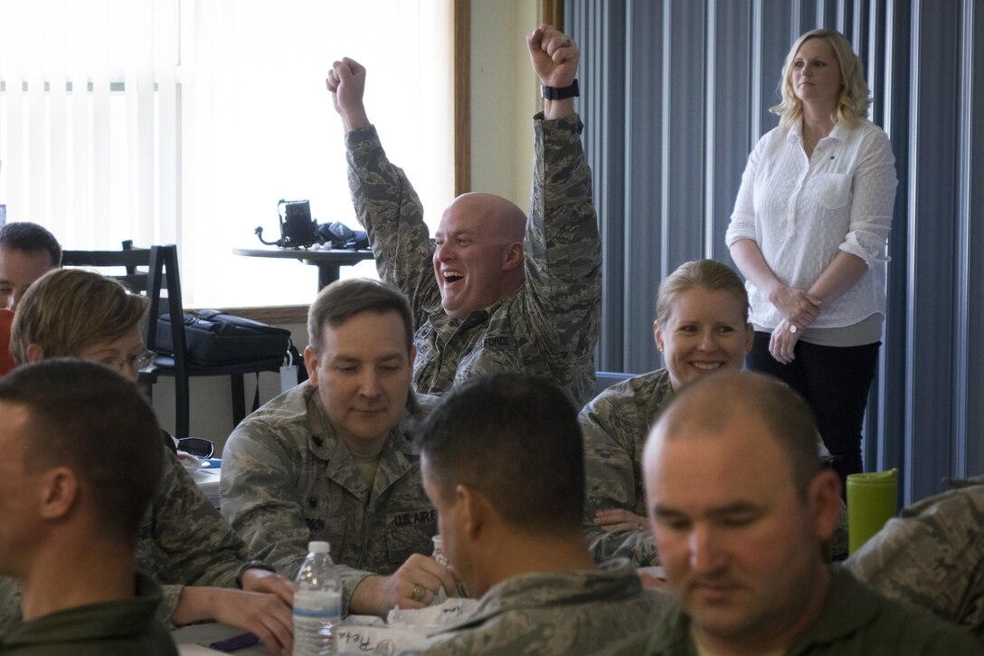 Maj. Jason Williams, 366th Security Forces Squadron commander, celebrates after hitting his intended target with a crumpled paper ball at Mountain Home Air Force Base, Idaho, April 19, 2016. Green Dot instructors aim to make the training fun through activities. (U.S. Air Force photo by Tech. Sgt. Samuel Morse/Released)