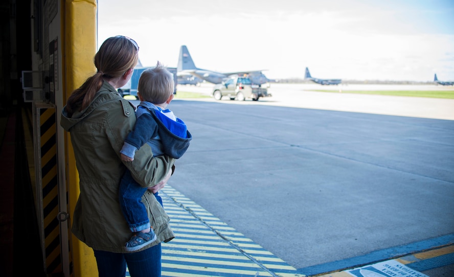 Family members look out at the flight line as multiple C-130 Aircraft are prepared to make their final 4 ship deployment out of Niagara Falls Air Reserve Station, N.Y., May 9, 2016. (U. S. Air Force photo by Tech. Sgt. Stephanie Sawyer)  