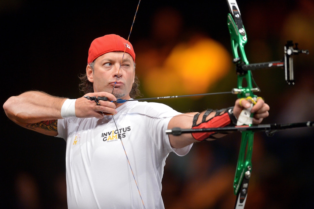 Nicolas Meunier, a Canadian team member, draws back and prepares to release an arrow as he competes in the archery finals during the 2016 Invictus Games in Orlando, Fla., May 9, 2016. Army photo by Staff Sgt. Alex Manne