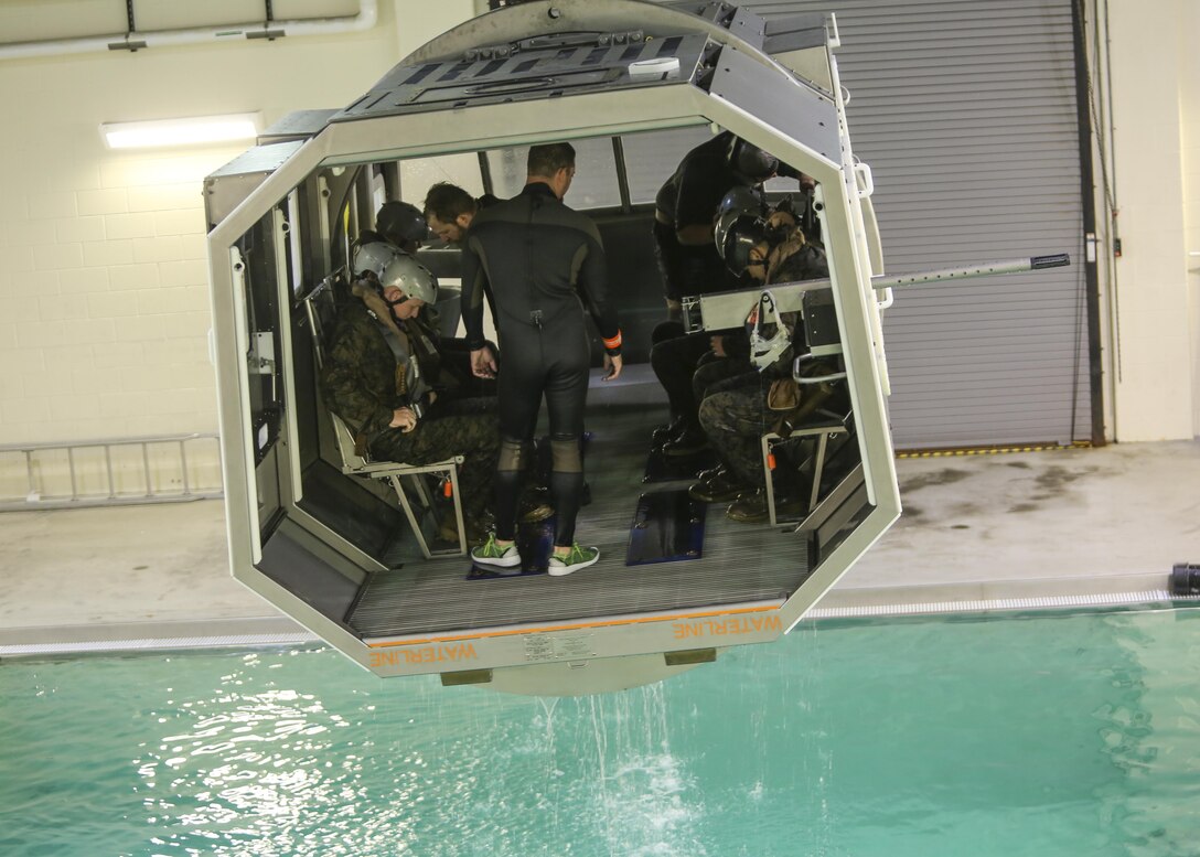 Marines with Marine Medium Tiltrotor Squadron 264 prepare to plunge into the water during survival training at Camp Lejeune, Apr. 28, 2016. The Marines used a simulated helicopter body while training for different underwater escape scenarios as qualification to be attached to a Marine Expeditionary Unit. (U.S. Marine Corps photo by Lance Cpl. Aaron K. Fiala/Released)