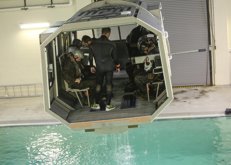 Marines with Marine Medium Tiltrotor Squadron 264 prepare to plunge into the water during survival training at Camp Lejeune, Apr. 28, 2016. The Marines used a simulated helicopter body while training for different underwater escape scenarios as qualification to be attached to a Marine Expeditionary Unit. (U.S. Marine Corps photo by Lance Cpl. Aaron K. Fiala/Released)