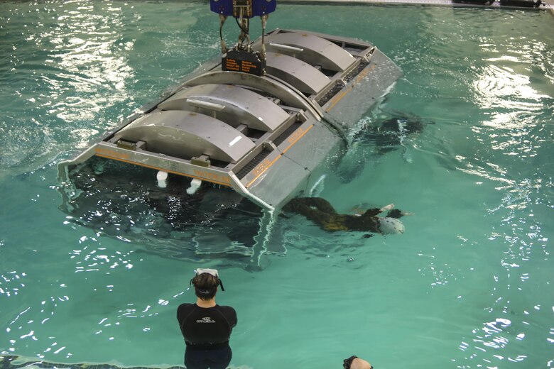 Marines with Marine Medium Tiltrotor Squadron 264 escape the cage after it sinks and flips upside down during water survival training at Camp Lejeune, Apr. 28, 2016. The Marines used a simulated helicopter body while training for different underwater escape scenarios as qualification to be attached to a Marine Expeditionary Unit.  (U.S. Marine Corps photo by Lance Cpl. Aaron K. Fiala/Released)