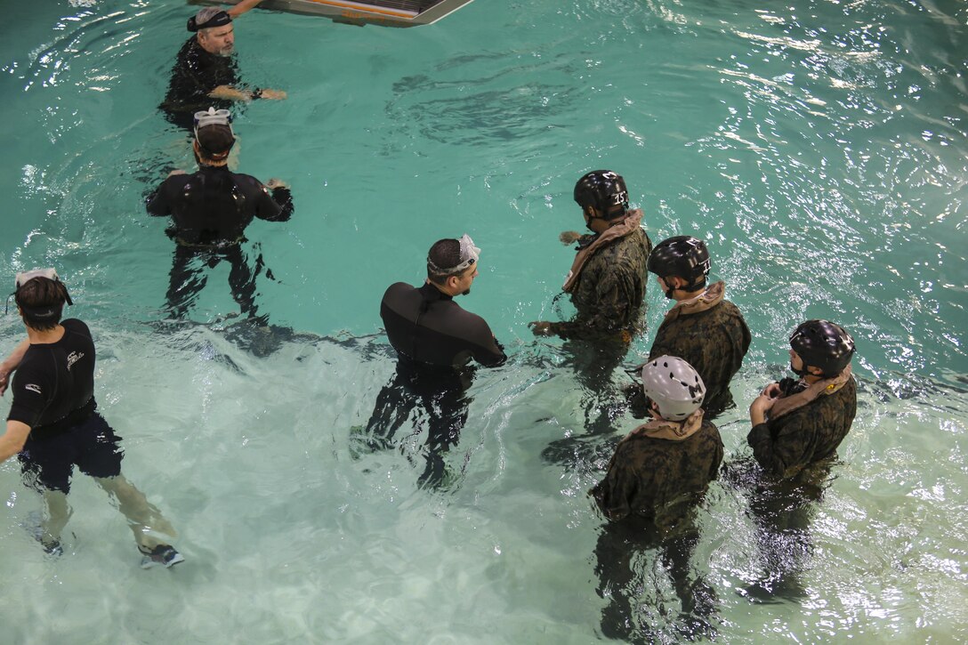 Marines with Marine Medium Tiltrotor Squadron 264 prepare to enter the helo dunker during water survival training at Camp Lejeune, Apr. 28, 2016. The Marines used a simulated helicopter body while training for different underwater escape scenarios as qualification to be attached to a Marine Expeditionary Unit. (U.S. Marine Corps photo by Lance Cpl. Aaron K. Fiala/Released)
