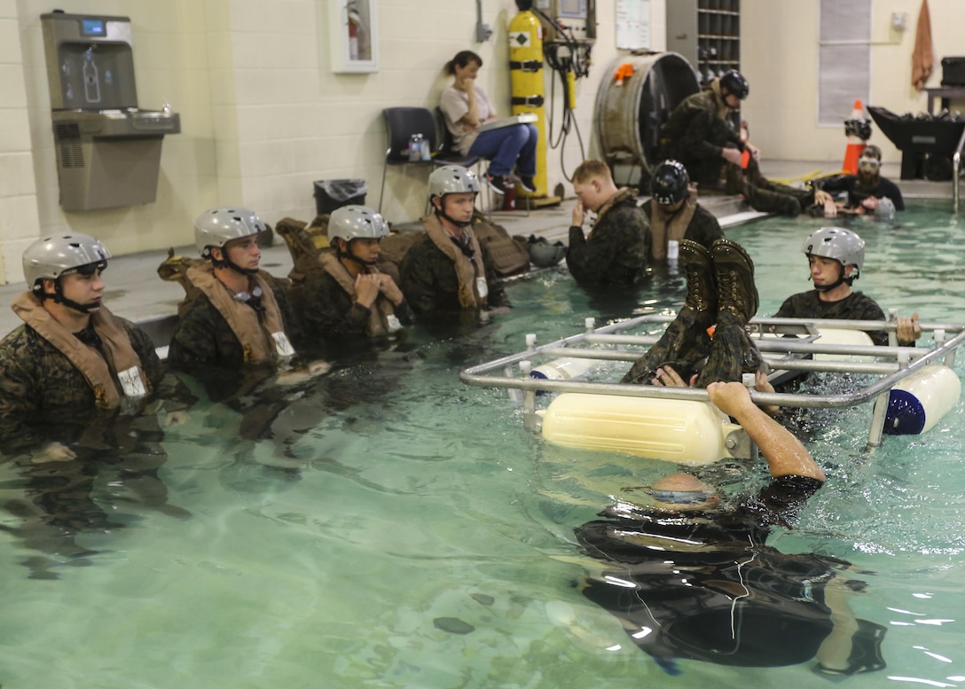 Marines with Marine Medium Tiltrotor Squadron 264 wait to escape the cage during water survival training at Camp Lejeune, Apr. 28, 2016. The Marines used a simulated helicopter body while training for different underwater escape scenarios as qualification to be attached to a Marine Expeditionary Unit. (U.S. Marine Corps photo by Lance Cpl. Aaron K. Fiala/Released)