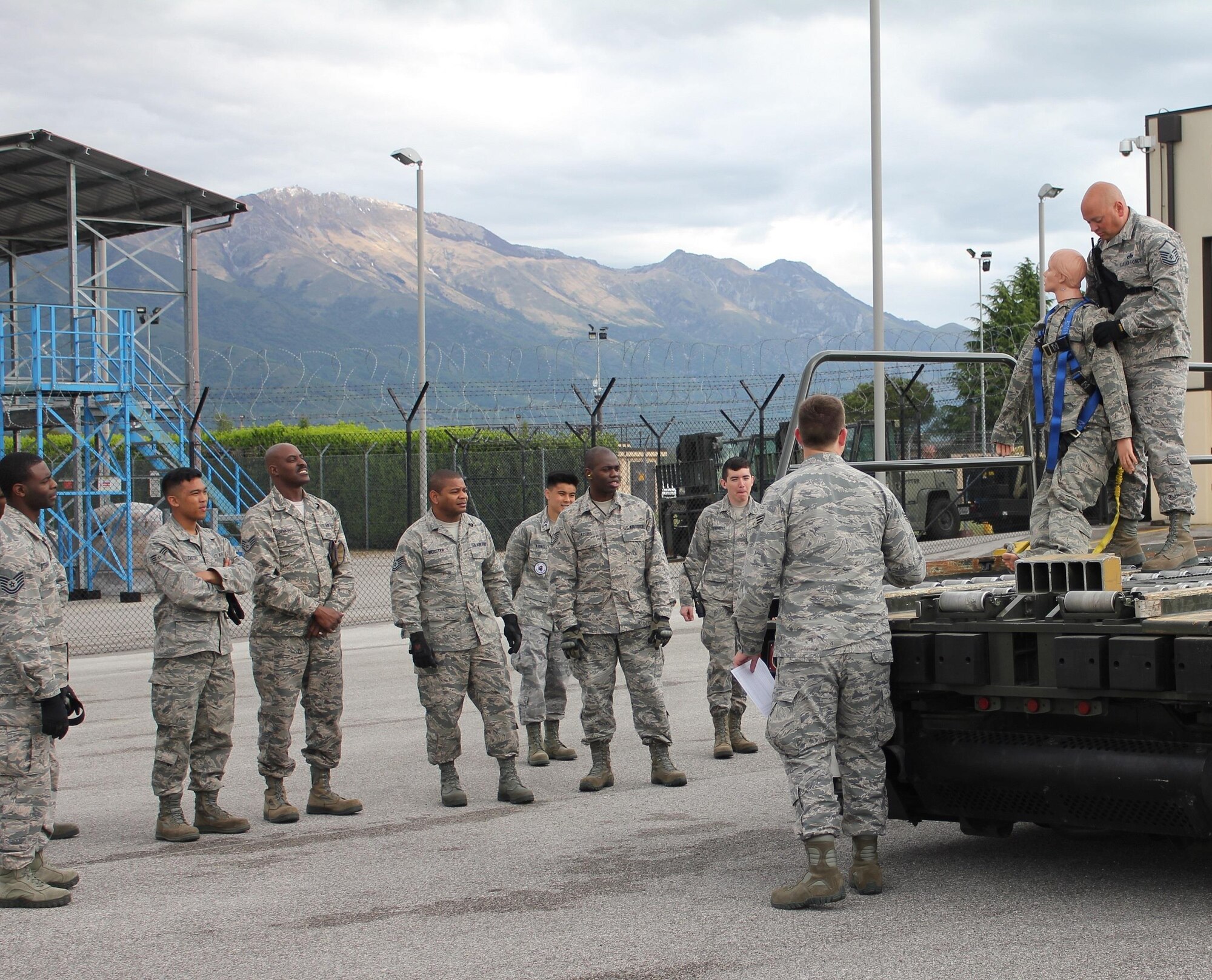 Reservists with the 71st Aerial Port Squadron and Airmen from the 724th Air Mobility Squadron receive fall protection training May 6, 2016 at Aviano Air Base, Italy. A human body dummy was used to simulate an accidental fall scenario to demonstrate first-response procedures when incidents occur as a result of aerial porters not following harness safety measures while working on air cargo loading vehicles. (U.S. Air Force photo/Staff Sgt. Patricia Gregg) 