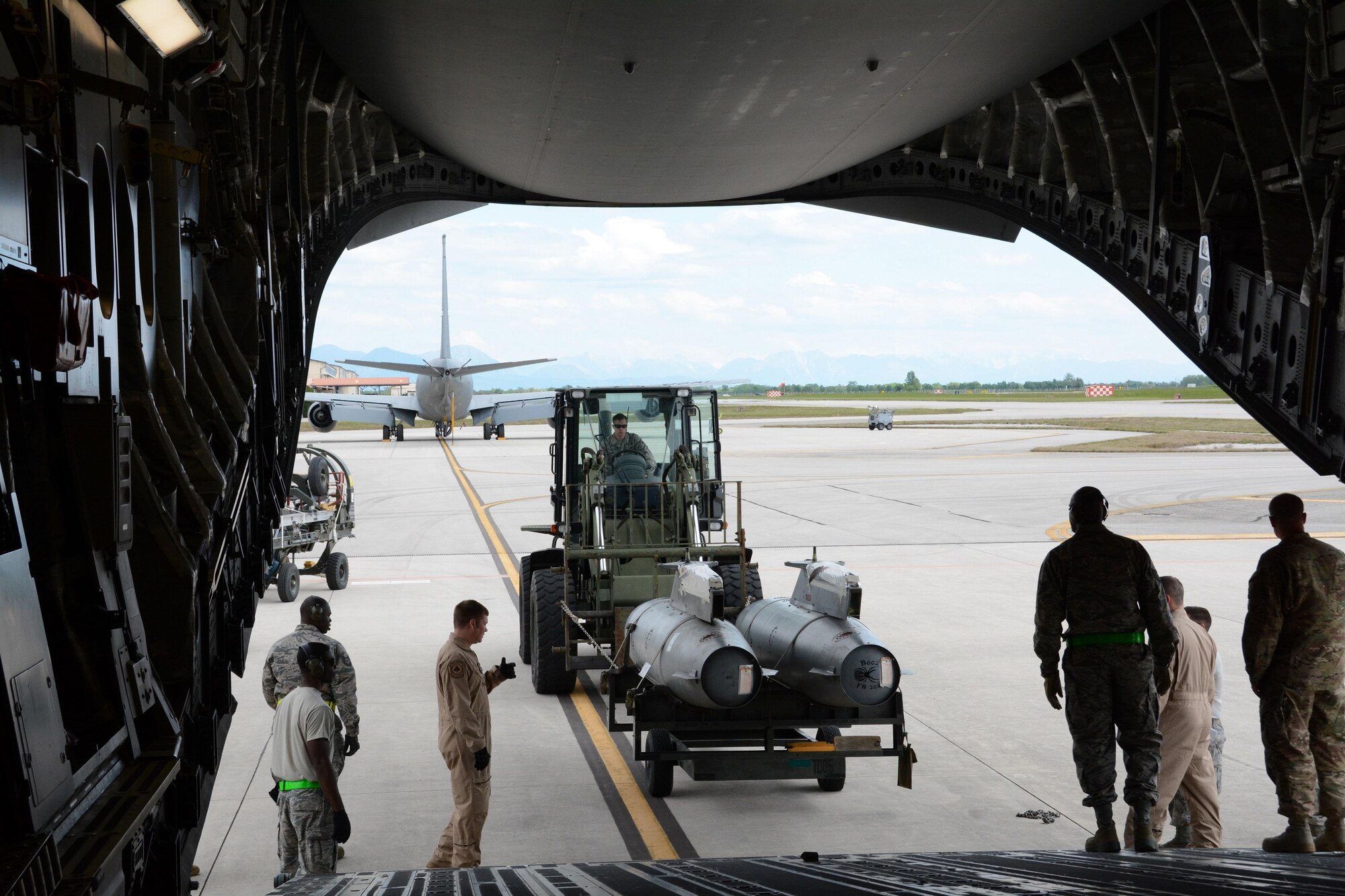 Members of the 724th Air Mobility Squadron and reservists from the 71st Aerial Port Squadron load extended fuel pods for an F-16 fighter jet aboard a C-17 Globemaster III at Aviano Air Base, Italy, May 5, 2016. The training objective for the reservists, whose squadron operates out of Joint Base Langley-Eustis, Va., to strengthen their proficiency in multiple aspects of their career field. (U.S. Air Force photo/Tech. Sgt. Mercedes Crossland)