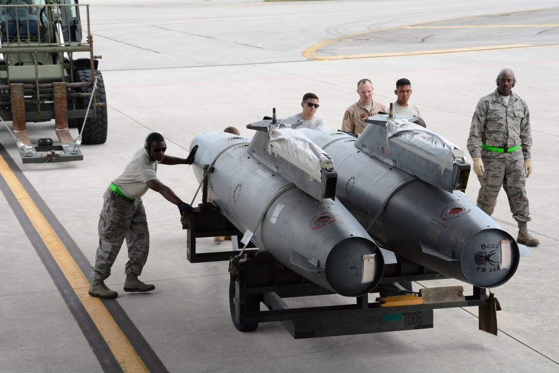 Members of the 724th Air Mobility Squadron and reservists from the 71st Aerial Port Squadron load extended fuel pods for an F-16 fighter jet aboard a C-17 Globemaster III at Aviano Air Base, May 5, 2016. The training objective for the reservists, whose squadron operates out of Joint Base Langley-Eustis, Va., to strengthen their proficiency in multiple aspects of their career field. (U.S. Air Force photo/Tech. Sgt. Mercedes Crossland)