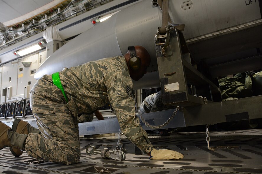 Staff Sgt. Malcom Jenkins, a reservist from the 71st Aerial Port Squadron, Joint Base Langley- Va., ensures cargo aboard a C-17 Globemaster III is securely tied down prior to take off at Aviano Air Base, Italy, May 6, 2016. The 71st APS arrived at Aviano May 2 to gain hands-on experience with processing, inspecting and ensuring air worthiness of cargo during their two-week annual tour. (U.S. Air Force photo/Tech. Sgt. Mercedes Crossland) 