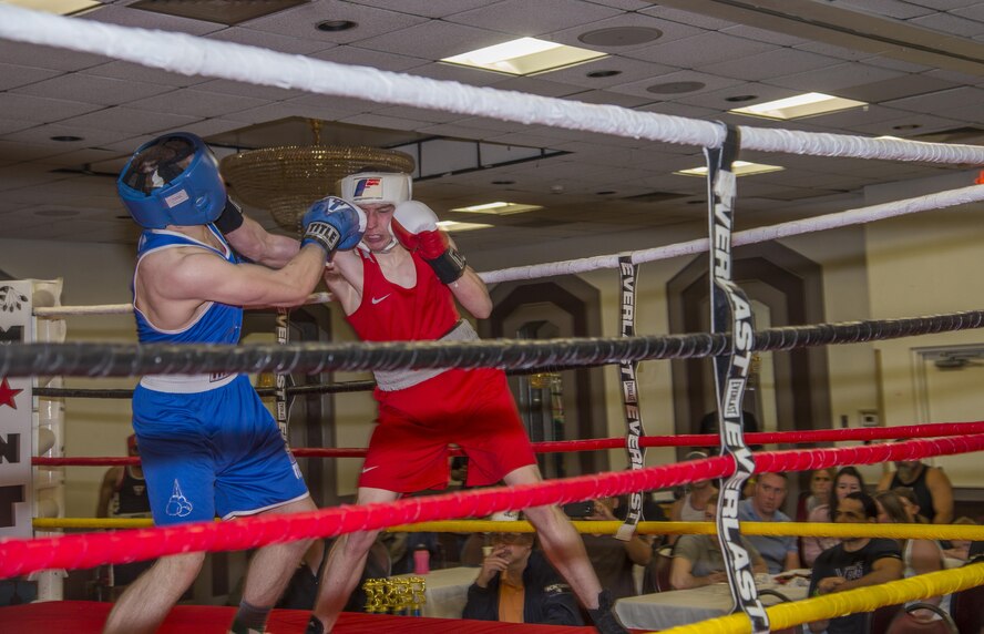 Staff Sgt. Ryan Savage, right, a 91st Security Forces Group evaluator, lands a punch on his opponent during a match in Minot, N.D., May 7, 2016. Savage is a current state and regional champion and will compete for national champion in the 152-pound weight class. (U.S. Air Force photo/Airman 1st Class Christian Sullivan)