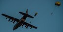 U.S. Air Force Special Operators and Army Special Forces Soldiers conduct a static line jump into an airfield to recover injured personnel from a helicopter crash during Emerald Warrior, May 7, 2016 at Camp Shelby, Mississippi. Emerald Warrior is a U.S. Special Operation Command-sponsored mission rehearsal exercise during which joint special operations forces train to respond to real and emerging worldwide threats. (U.S. Air Force photo by Senior Airman Colville McFee)