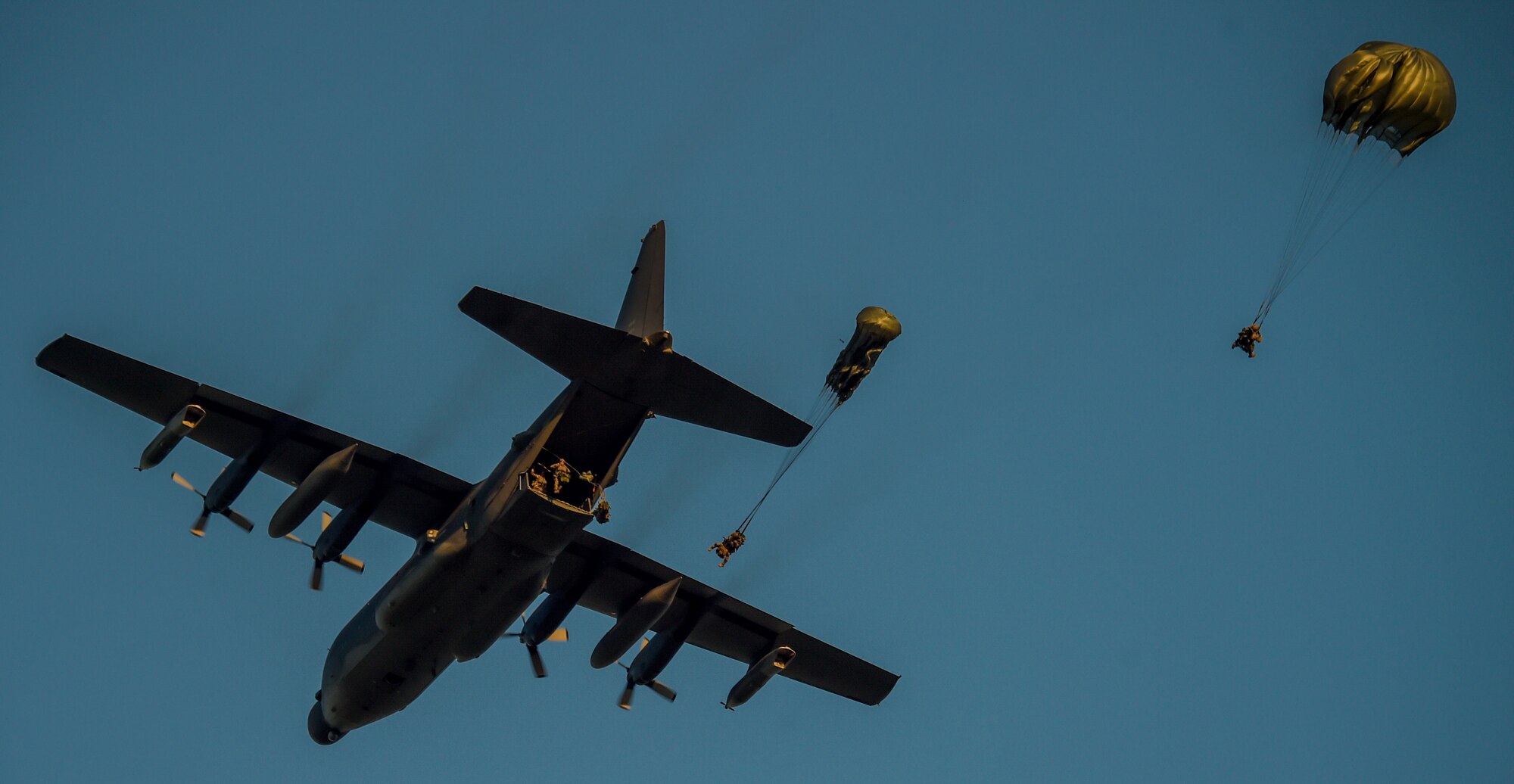 U.S. Air Force Special Operators and Army Special Forces Soldiers conduct a static line jump into an airfield to recover injured personnel from a helicopter crash during Emerald Warrior, May 7, 2016 at Camp Shelby, Mississippi. Emerald Warrior is a U.S. Special Operation Command-sponsored mission rehearsal exercise during which joint special operations forces train to respond to real and emerging worldwide threats. (U.S. Air Force photo by Senior Airman Colville McFee)