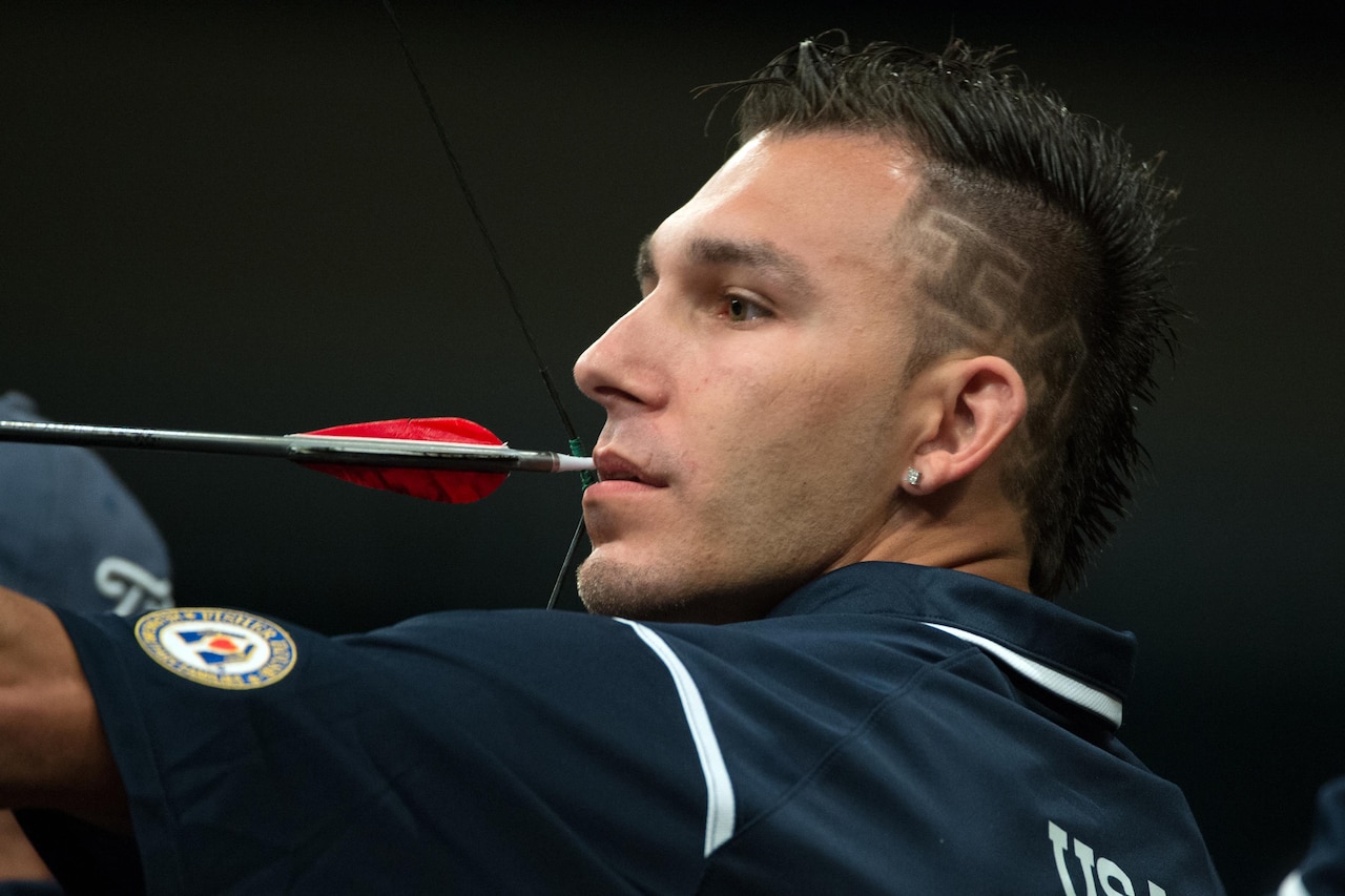 Robbie Gaup, a U.S. team archer, aims and prepares to release an arrow during the archery competition at the 2016 Invictus Games in Orlando, Fla., May 9, 2016. DoD photo by EJ Hersom