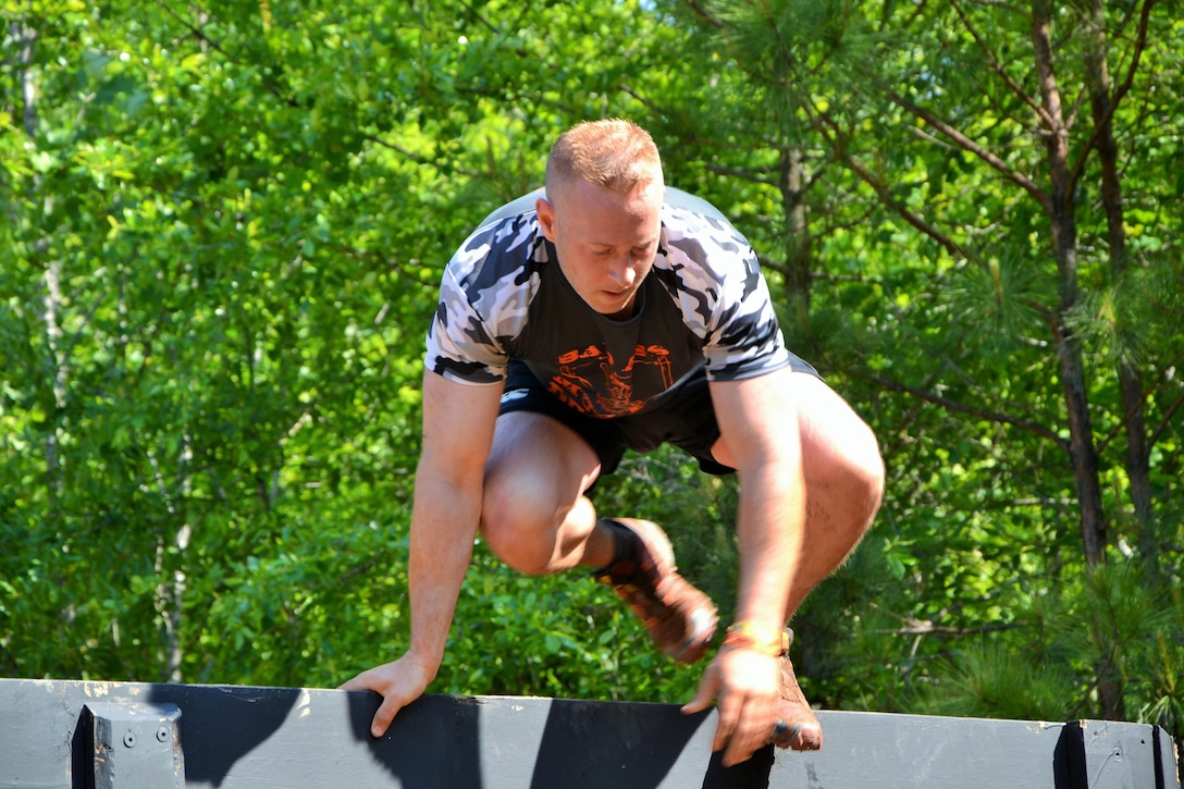 Eric Hanson, from Baltimore, Md., shows how easy it is to climb over the "Berlin Wall" at the 2016 Atlanta Tough Mudder obstacle course event. Partnered with the Army Marketing Research Group, the muddy event was held May 7 and 8, 2016, at Bouckaert Farms in Fairburn, Ga.