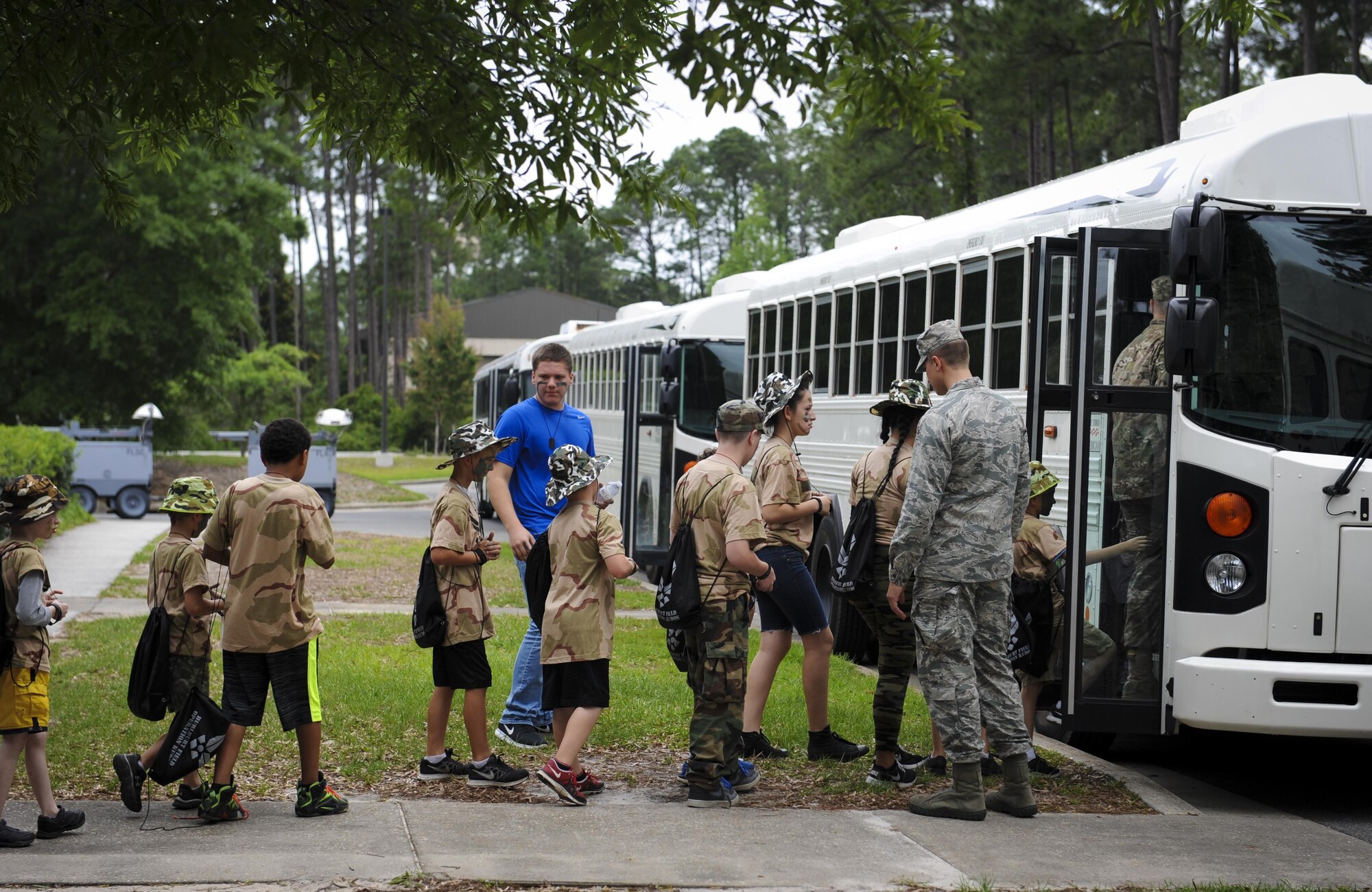 Children board a bus to travel to their “deployment zone” during Operation Kids Understanding Deployment Operations at Hurlburt Field, Fla., April 30, 2016. At the “deployment zone” children were able to explore machines and equipment from the 823rd RED HORSE squadron, the 1st Special Operations Civil Engineer Squadron fire department and the 1st Special Operations Medical Group. They also watched demonstrations from the 1st Special Operations Security Forces Squadron. (U.S. Air Force photo by Senior Airman Meagan Schutter)