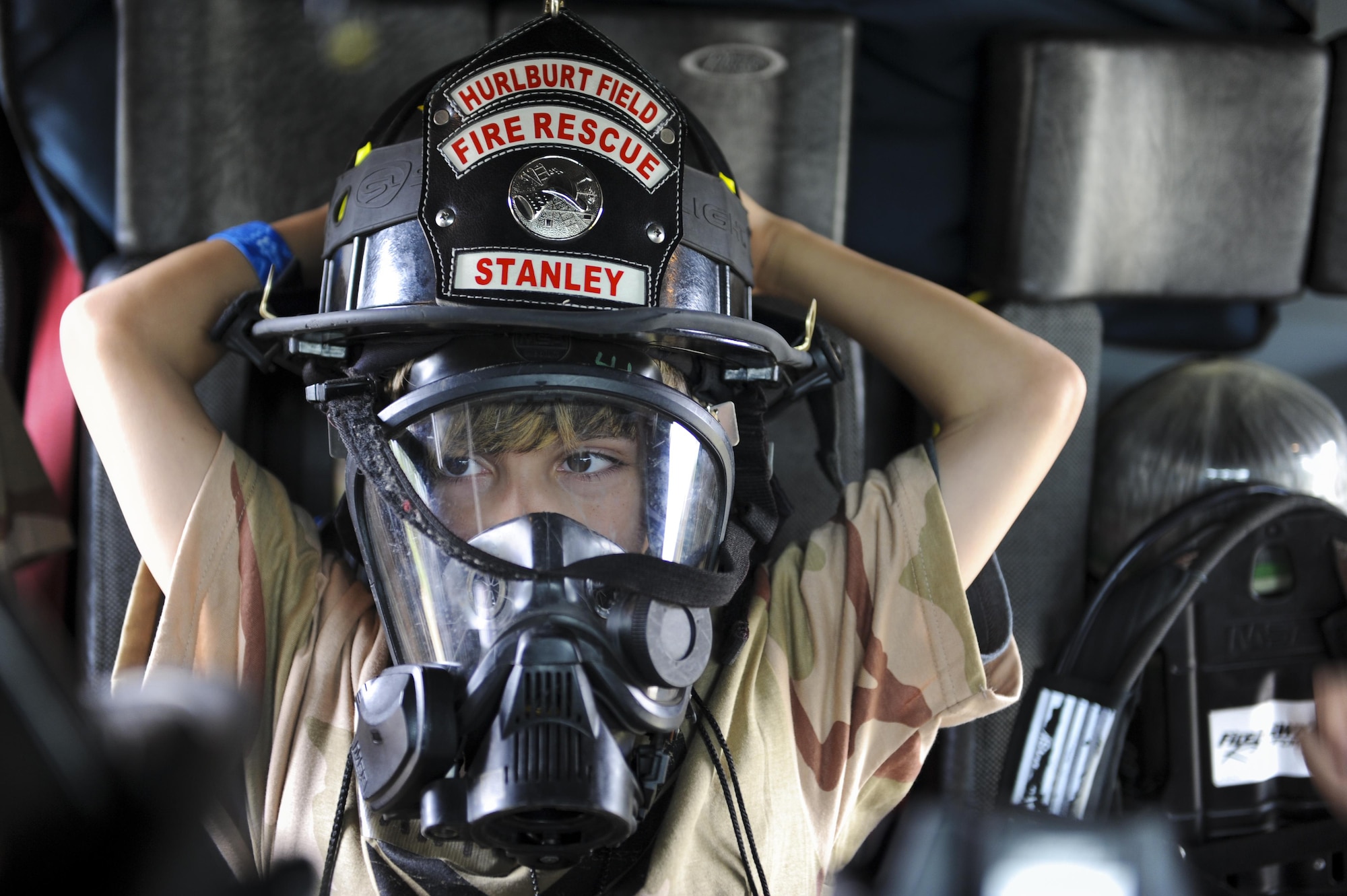 A military child relaxes in a fire truck during Operation Kids Understanding Deployment Operations at Hurlburt Field, Fla., April 30, 2016. Operation KUDOS is an educational event to help build resiliency in military youth by engaging them in activities that simulate the pre-deployment experience. The event concluded with a “homecoming” where parents welcomed back their children. (U.S. Air Force photo by Senior Airman Meagan Schutter)