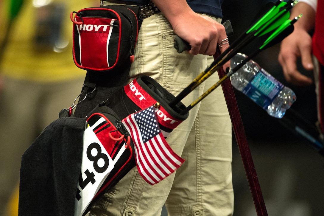 An American flag hangs from the quiver of Chasity Kuczer, an Army athlete, during the archery competition at the 2016 Invictus games in Orlando, Fla., May 9, 2016. DoD photo by EJ Hersom