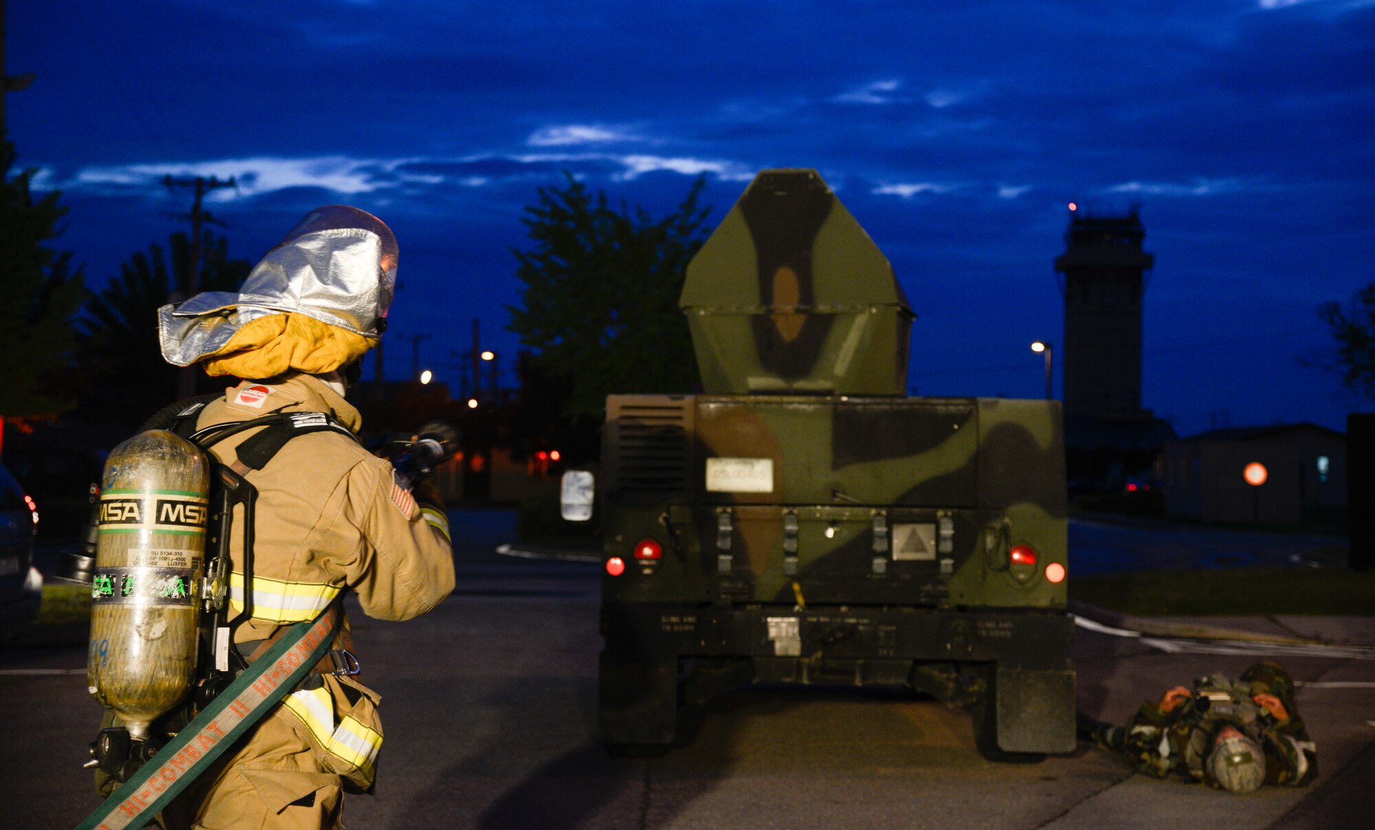 A fire prevention crew member from the 51st Civil Engineer Squadron simulates dousing a defense-oriented vehicle during Exercise Beverly Herd 16-01 May 10, 2016, at Osan Air Base, Republic of Korea. BH 16-01 is a week-long readiness exercise for the 51st Fighter Wing which includes a plethora of scenarios like Chemical, Biological, Radioactive, and Nuclear, active shooter and opposing forces. (U.S. Air Force photo by Senior Airman Dillian Bamman/Released)