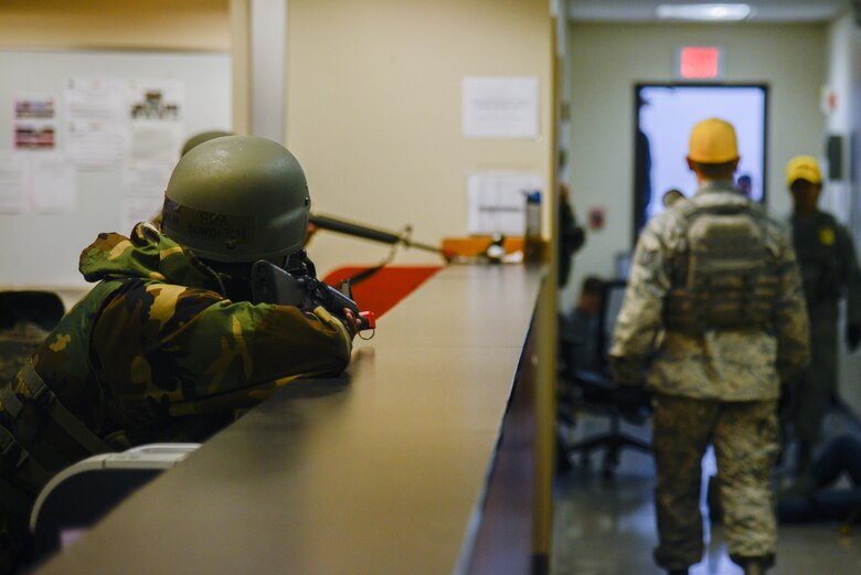 Members from the 51st Operations Support Squadron base operations flight stand ready with simulated firearms during an opposing forces scenario for Beverly Herd 16-01 May 10, 2016, at Osan Air Base, Republic of Korea. BH 16-01 is a week-long readiness exercise for the 51st FW which includes a plethora of scenarios like Chemical, Biological, Radioactive, and Nuclear response, active shooter and opposing forces. (U.S. Air Force photo by Senior Airman Dillian Bamman/Released)