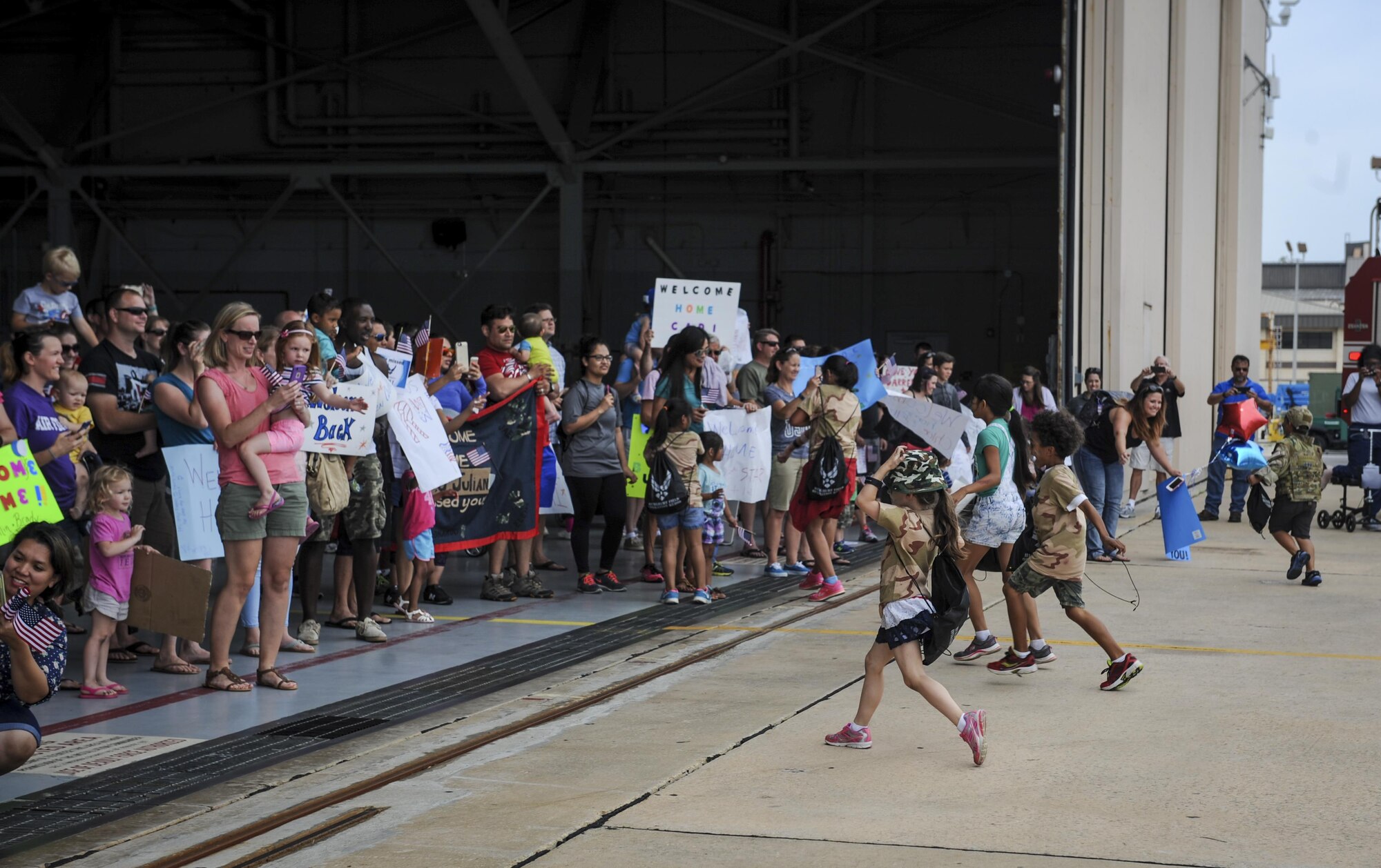 Children run to their parents at a “homecoming” during Operation Kids Understanding Deployment Operations at Hurlburt Field, Fla., April 30, 2016. The homecoming helped show children what it feels like to return to family members after a deployment. (U.S. Air Force photo by Senior Airman Meagan Schutter)
