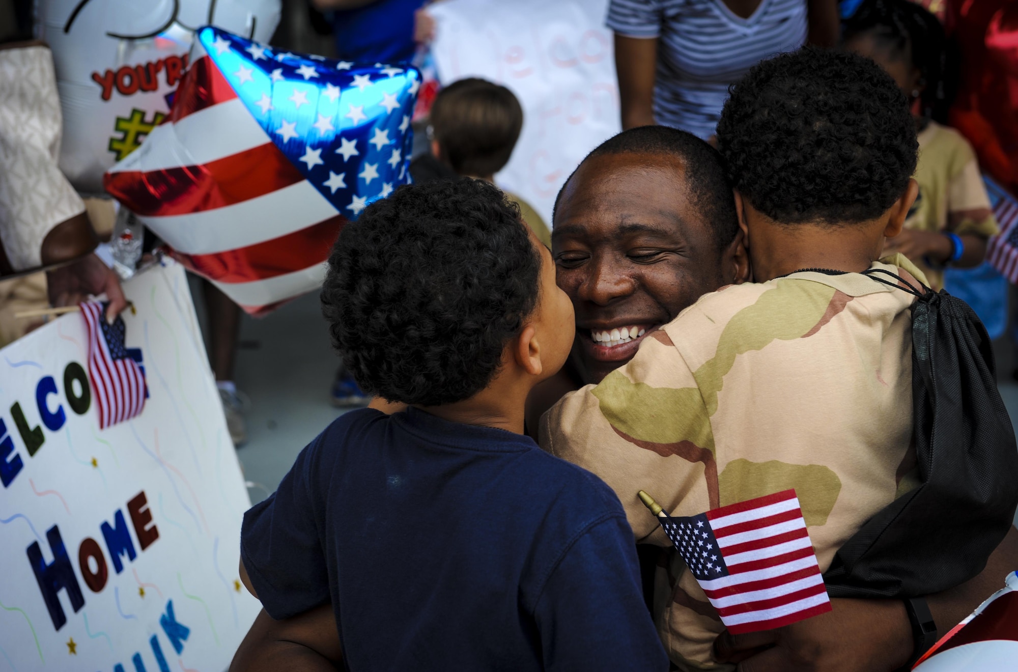 Master Sgt. Quintin Johnson, a superintendent with the 1st Special Operations Wing, hugs his children at a “homecoming” during Operation Kids Understanding Deployment Operations at Hurlburt Field, Fla., April 30, 2016. The School Liaison Program hosted KUDOS to educate kids on the deployment process, engaging them in activities that help show children similar situations their parents go through during pre-deployment. (U.S. Air Force photo by Senior Airman Meagan Schutter)